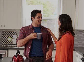 smiling couple enjoying a cup of coffee